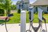Modern apartment complex featuring eco-friendly electric vehicle charging stations and lush green surroundings at our welcoming apartments in Westford, MA. | Princeton Westford | Luxury Apartments In Westford MA