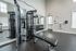Maintain your fitness routine at our well-appointed gym featuring diverse equipment options for every workout preference. | Mill & 3 Apartments | Mill & 3 Apartments Apartments