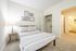This primary bedroom with attached bath offers convenient privacy and comfort with ensuite bathroom access. | Mill & 3 Apartments | Apartment in Chelmsford, MA