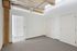 The airy bedroom provides bright, open atmosphere with natural light and comfortable proportions throughout.  | 381 Congress Lofts | Boston Apartments