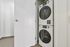 Your modern laundry area features a sleek stacked washer and dryer set, enhancing convenience and efficiency in a compact space. | 381 Congress Lofts