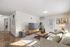 Bright and modern living room with elegant decor, neutral tones, and a cozy atmosphere. Features a comfortable sofa, stylish coffee table, and large TV, ideal for relaxation and entertaining.