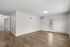 Bright and spacious living area with modern wood flooring, fresh neutral walls, and ample natural light, perfect for a contemporary lifestyle.