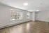 Bright, airy living space featuring large windows and elegant hardwood flooring, perfect for modern living.