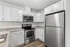 Modern kitchen with sleek stainless steel appliances, elegant white cabinetry, and granite countertops.