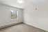 Bright and spacious room with large window offering serene outdoor views, perfect for a modern and cozy living space.