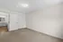 Spacious bedroom with plush carpeting and bright light, leading into a beautifully finished bathroom, creating a cozy and inviting ambiance.