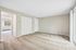 Bright, spacious room with plush carpet and ample natural light, featuring a closet and a large window offering a view.