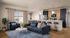 Princeton Wilmington Apartments | Modern open-concept living area with plush sofa, sleek kitchen island with bar stools, and vibrant dining space, featuring elegant decor and ample natural light. | Apartments for Rent in near boston