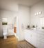 Elegant bathroom with modern fixtures, warm wood flooring, and stylish decor for a relaxing space.