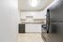 Modern kitchen with sleek appliances, white cabinetry, and spacious countertops.