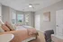 Inviting bedroom with elegant decor, large windows, and a cozy, welcoming atmosphere.