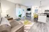 Modern, open-concept living area featuring sleek flooring, elegant lighting, and a contemporary kitchen with a stylish breakfast bar.