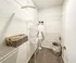 Elegant walk-in closet with ample shelving, organized white baskets, and cozy carpet flooring, exuding a sense of spaciousness and modern utility.