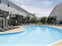 pool area with palm tree and apartments in back