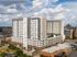 Contemporary high-rise apartment building with a rooftop terrace, offering stunning city views and modern living spaces.