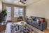 Bright and modern living room with chic furniture, stylish decor, and large windows offering a stunning view.