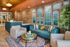 Inviting lounge area with modern decor, featuring a stylish teal sofa, cozy armchairs, and vibrant wall art, perfect for relaxation.