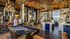 Luxurious apartment club lounge featuring a stylish pool table, elegant chandeliers, and inviting bar area with city views.