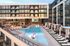 Luxury apartment complex with modern architecture, featuring a stunning outdoor pool, stylish lounge chairs, and elegant cabanas for ultimate relaxation.