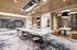Luxurious coworking space featuring booths, private conference center, on site printing, and ambient lighting.