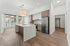 Modern kitchen with sleek cabinetry, stainless steel appliances, and a chic island in a bright, open space with floor-to-ceiling windows.