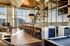 Luxurious modern lounge with floor-to-ceiling windows, chic bar seating, and elegant lighting fixtures.