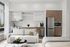 Modern apartment interior showcasing an open kitchen with sleek cabinetry, contemporary appliances, and a cozy living area with stylish decor.