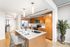 Modern kitchen with chic wooden cabinetry, sleek stainless steel appliances, and a stylish breakfast bar with seating.