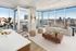 Luxurious apartment with modern decor, featuring floor-to-ceiling windows offering stunning cityscape views, spacious living area, elegant furnishings, and ample natural light.