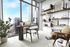 Bright modern home office with panoramic city views, stylish decor, and cozy seating, ideal for productivity and inspiration.