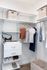 Modern walk-in closet featuring stylish shelving, hanging space, and organized storage solutions with chic woven baskets.