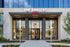 Elegant entrance of One Rangers Way with modern glass facade and inviting landscaping.