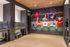 Chic pet wash station with artistic sports-themed mural and modern amenities, featuring sleek stainless steel wash areas.