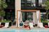 Luxurious poolside retreat with stylish loungers, elegant cabana, and modern architecture in the background.