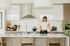 Modern kitchen with sleek white cabinetry and a stylish island, featuring elegant decor and a cozy atmosphere.