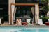 Luxury poolside retreat with comfortable lounge chairs and elegant cabanas, perfect for relaxation and leisure.