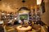 Inviting lounge area with modern decor, featuring cozy seating, a chess game, and a large TV, perfect for relaxation and socializing.