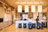 Bright and welcoming modern kitchen space with elegant wooden cabinets, pendant lighting, and a spacious island, perfect for social gatherings.