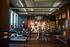 Modern gym with panoramic windows, featuring cardio and strength equipment, alongside vibrant sports-themed decor.