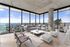 Luxurious modern living room with panoramic city views, featuring sleek furniture, stylish decor, and floor-to-ceiling windows.