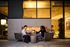 Chic outdoor seating area with a cozy fireplace, perfect for intimate gatherings and relaxation in a modern apartment setting.