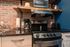 floating shelves above stove in a studio apartment