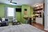 green accent wall in a micro studio apartment