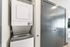 Stack-able washer and dryer in studio apartment.