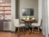 Dining table and chairs in furnished studio apartment