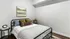 Charming bedroom with a modern metal bed, soft pillows, and elegant decor, featuring a scenic wall painting.