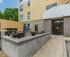 Inviting apartment entrance with a cozy outdoor patio and modern seating area, perfect for relaxation and socializing.