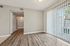 Bright and inviting apartment with sleek hardwood floors and large sliding glass doors leading to a private balcony.