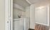 Modern utility closet with a sleek washer and dryer set, complemented by elegant hardwood flooring at Driscoll Place Apartments in Texas